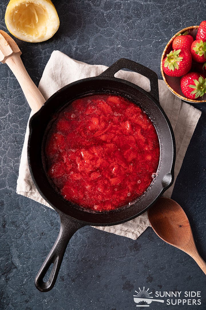 Making strawberry sauce in a skillet.