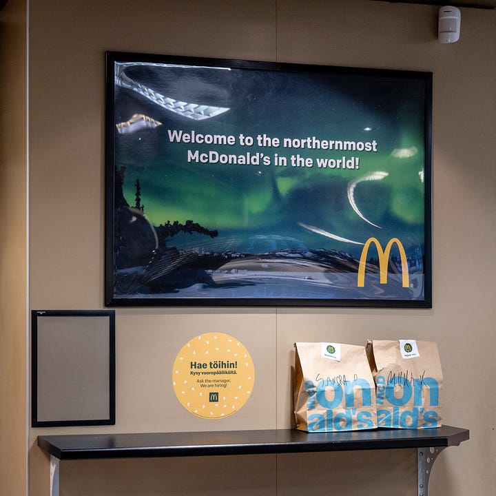 Postcards, the snow-covered drive thru, Happy Meal bird feeder, and poster from the McDonald's in Rovaniemi, Finland