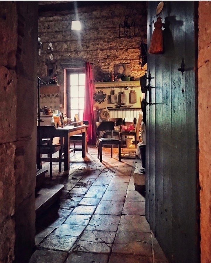 Open door to a french farmhouse kitchen.