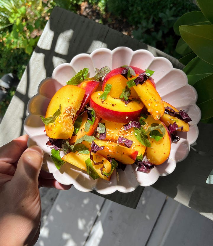 Hand holding peach perilla salad, hand holding watermelon perilla salad