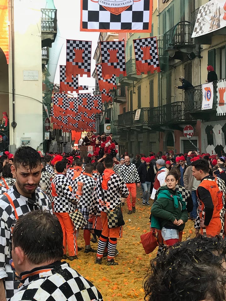 People throwing oranges, others resting after the throwing has finished, a hand holding an orange. All taken in Ivrea.