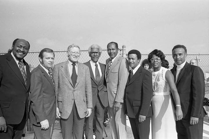Left to right: Bayard Rustin (4th from left) poses with Los Angeles Chapter A. Philip Randolph Institute President Samuel McNeal, Jr. (left), LA County AFL-CIO Executive Secretary Sigmund Arywitz (3rd from left), Tom Bradley (5th from left), A. Philip Randal Institute Field Director Lois Felder (2nd from right), Arnett Hartsfield (right) and others during an event to honor Mr. Rustin at the home of singer Ray Charles, Los Angeles, 1973; Bayard Rustin talking with Tom Bradley, Los Angeles, 1973; Bayard Rustin standing between Sigmund Arywitz and Samuel McNeal, Jr., Los Angeles, 1973; Bayard Rustin, Gwen Green, and Ken Orduna standing together, Los Angeles, 1973. All photos by Guy Crowder ©Tom and Ethel Bradley Center