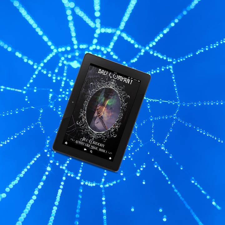 Image one: in the upper left. A ghostly woman wearing a white bodice stares menacingly. She's surrounded by blue mist. The kindle edition of Bad Company floats in front of her. Image two, in the upper right. A blue background with a dew-covered spider web. The kindle edition of Bad Company is "caught" in the web. Image three in the lower right. A caucasian hand is outstretched, as seen from the POV as if it's your hand reaching out. Gold and silver bubbles and glitter surround the hand, which is holding the kindle edition of Bad Company. Image four, in the lower left. A gray background with the silhouette of a clawed human-ish hand reaching from the middle left toward the middle right. It's reaching for the kindle edition of Bad Company.