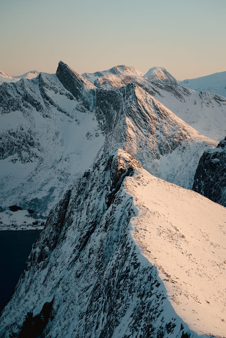 Landscapes of the island of Senja as seen from the summit of Husfjellet. Mountains in Norway covered in snow