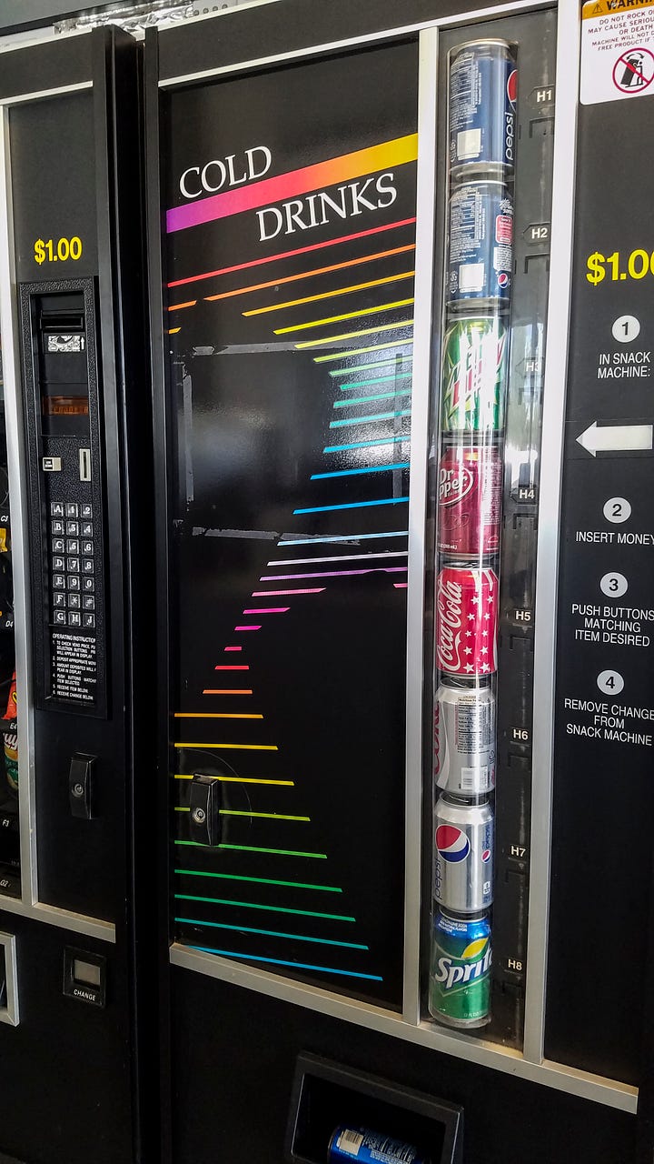 Two photos. Photo of a soda machine. The main panel is black with bright, horizontal, neon strips (in the colors of the rainbow) running across the panel. There are two large black areas in the shape of soda cans. The sodas available are displayed to the right, in a tall, clear tube - Mountain Dew, Dr. Pepper, Coca Cola, Diet Coke, Pepsi - with prices alongside each can. 4 step instructions appear on the right.  Photo of a white washing machine. It is a top load machine and the door is open. The coin feed is on the right. To the right of the washing machine is a white utility sink with a long neck faucet spout. Behind, on the wall is a rectangular white dispenser of "Soap / Bleach / Softeners". TO the right is a change machine. Between the two is a sign, "Management reserves right to refuse service to anyone" in all caps, red letters.
