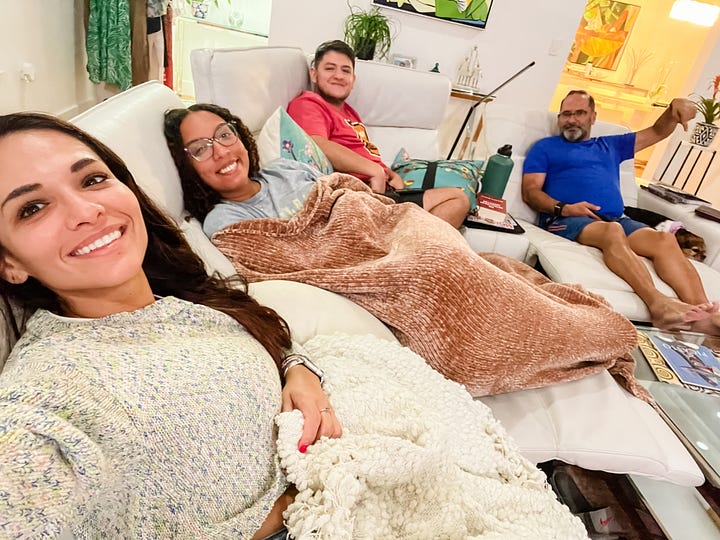 Selfie image of woman and her beagle-King Charles Cavalier Spaniel mix dog; Selfie image of two women and two men and a dog on a couch in a living room.