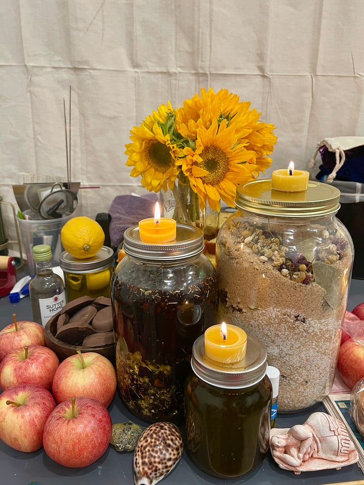 Images of a lush altar, set up on an art desk, dedicated to Juno-Ninsiana for the wealth, prosperity, and financial success of the participants.