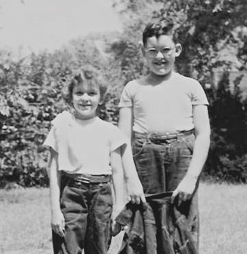 The girl on the left is in a bathing suit and has carefully styled short hair and bangs. The girl on the right is standing next to an older boy. They are both wearing blue jeans and T-shirts. Her hair looks permed, but messy.