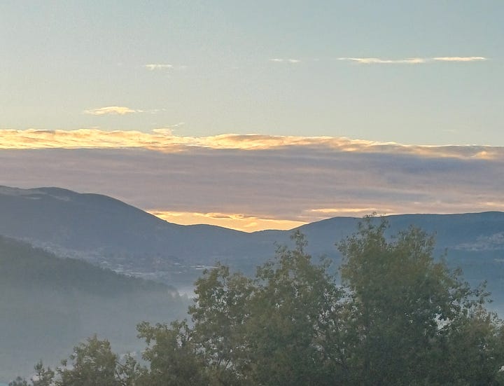 Left: sun rising behind clouds and mountains, with fog in foreground. Right: sun about to rise over mountains in nearly cloudless sky, taken by author from her window.