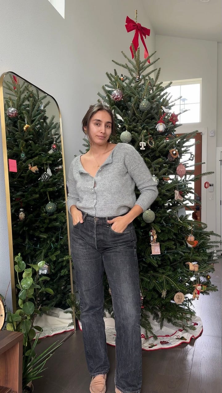 women standing in front of christmas tree