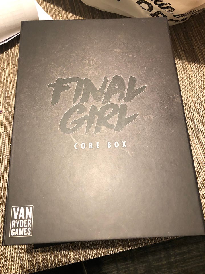A pair of photos of the boxes for the Final Girl core box and the Camp Happy Trails expansion