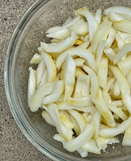 Four photos of step by step of lemon peels being prepared by separating zest from pith, slicing and placing in plastic bags to travel.