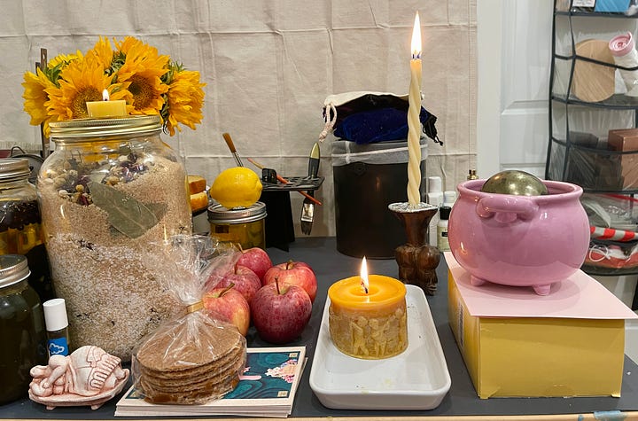 Images of a lush altar, set up on an art desk, dedicated to Juno-Ninsiana for the wealth, prosperity, and financial success of the participants.