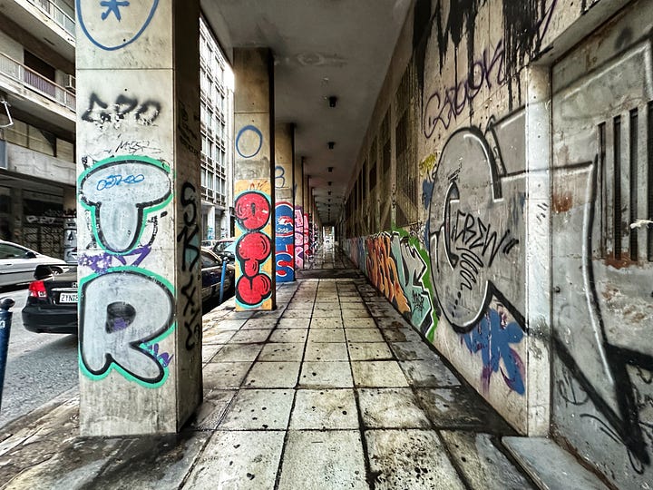 Photos of downtown Athens, statues, buildings with graffiti 