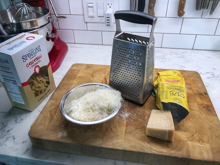A gallery of four images. 1: Sausages that have had their casings removed 2: Chopped rapini in a colander. It is wet from rinsng. 3: A bowl of grated Parmesan cheese beside the grater and a hunk of cheese 4: Minced garlic in a small prep bowl
