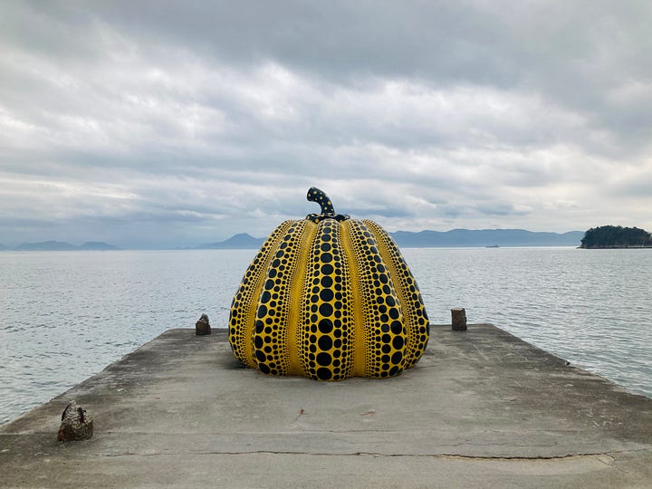 4 images: A sakura tree, a giant pumpkin by Yayoi Kusama, a room full of mirrors and metallic eggs, and a quiet street in Kyoto.