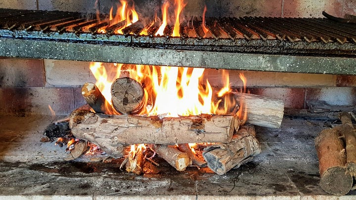 Wood fire under a grill. A table covered in spices. Photos by Bruno Forchieri and Agnieszka Stankiewicz via Unsplash.