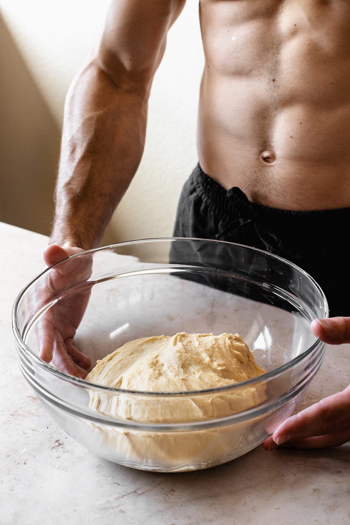 Shirtless man showing steps to make vegan olive oil brioche dough