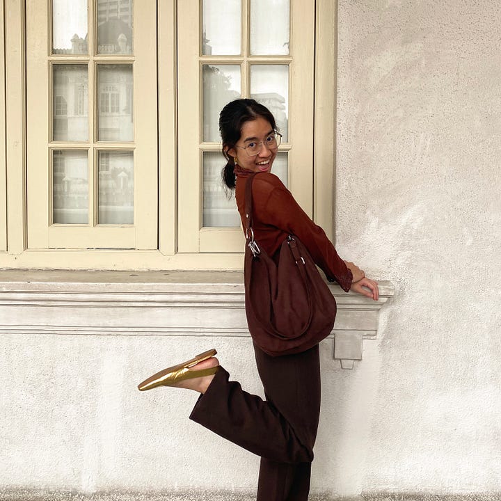 Author wearing a brown kebaya top with brown pants and bag and golden slingback flats.