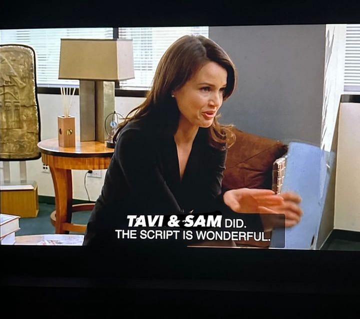 Screenshots from the television show “Entourage” showing actress Carla Gugino, a woman with long brown hair, seated in an office setting. Subtitles are visible at the bottom of the screen, displaying the text, “IT’S EDITH WHARTON’S ‘GLIMPSES OF THE MOON.’ STUDIO’S BEEN TRYING TO TACKLE IT FOR YEARS. NOBODY COULD GET A HANDLE ON IT. TAVI & SAM DID. THE SCRIPT IS WONDERFUL.”  