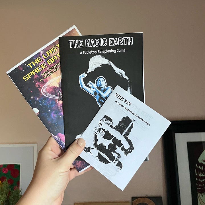 Me holding up some of my favorite zines purchased at Wasted Ink Zine Distro or Phoenix Zine Fest