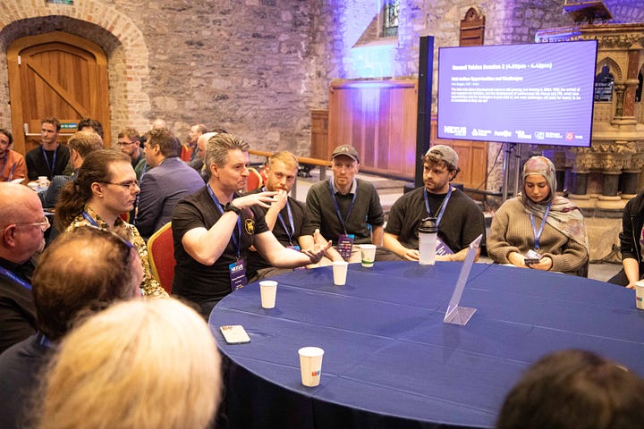 Me hosting the AI for games roundtable, and the second of me delivering a talk to a crowd of over 150 people. in a church.