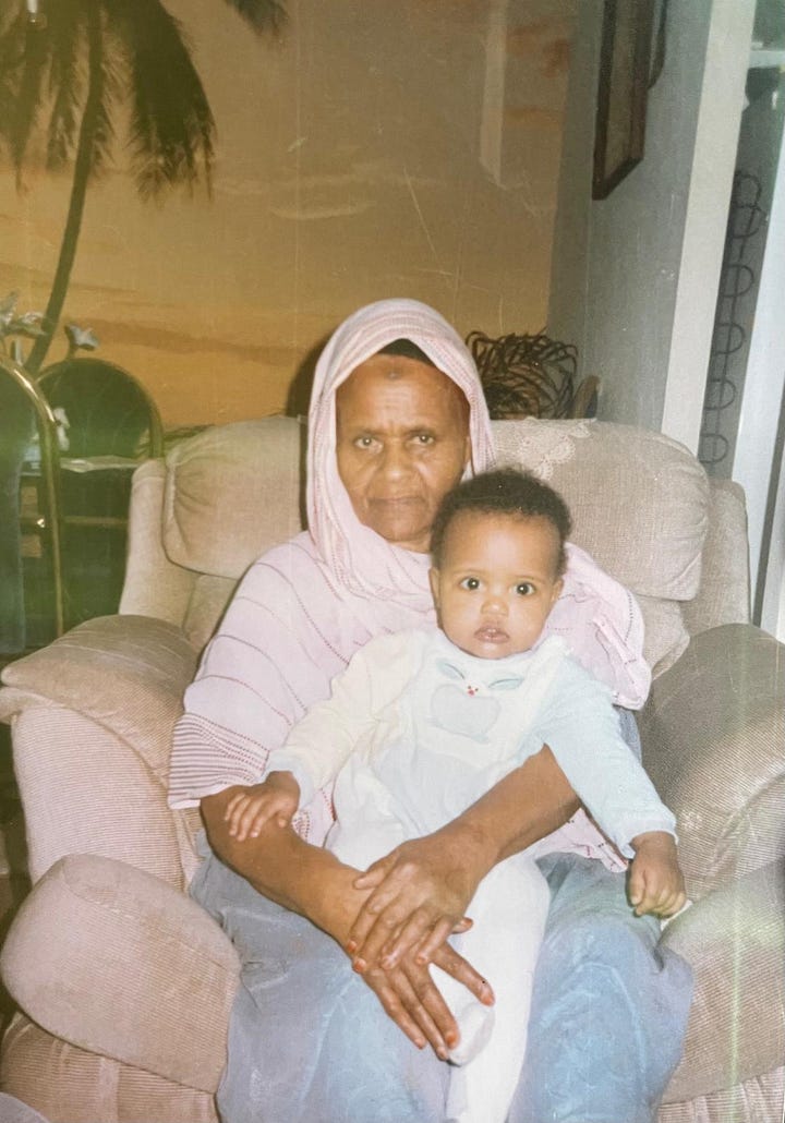 My paternal grandmother and I in 1991, shortly after she escaped from the war. She arrived with my uncle Musa, who carried her in a wheelbarrel as they escaped Somalia on foot to Ethiopia. She raised me for the first five years of my life before passing away from cancer (discovered in Canada). Musa prematurely died a few years shortly afterward, too. This photograph sits in my living room, always in near view; the bruise on her forehead reminds me of what a lifetime of prayers looks like.