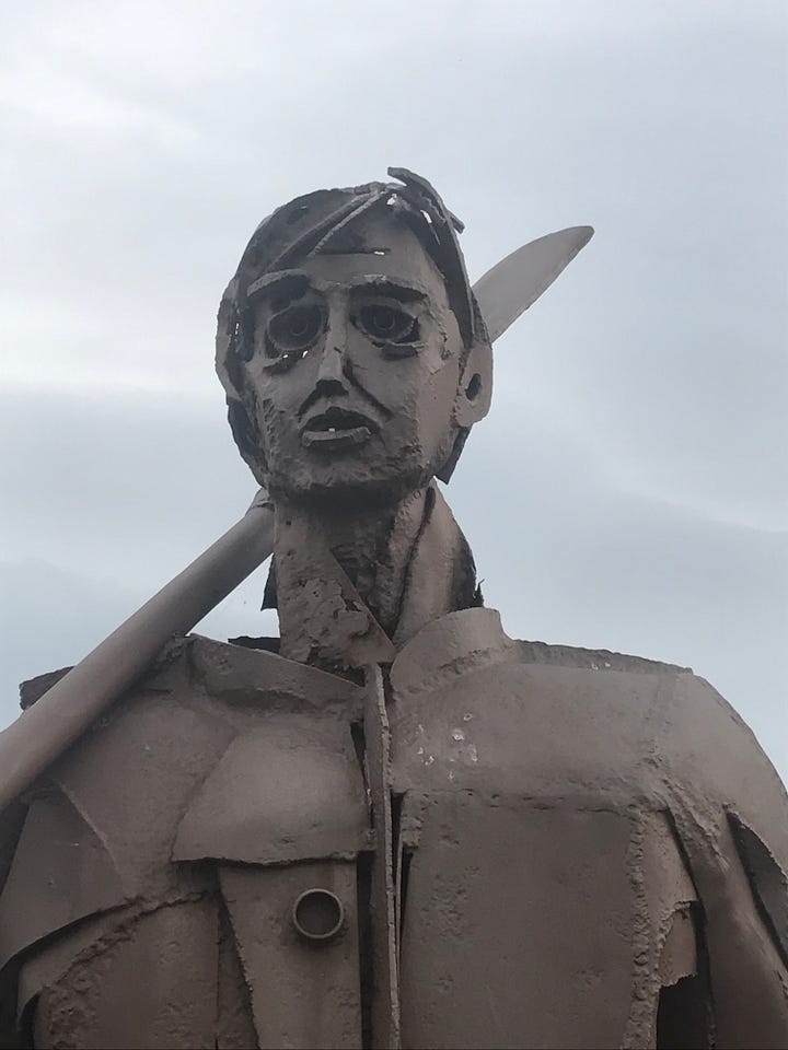 Three images of sculptures dedicated to the mighty anchovy in the port of Santoña, northern Spain.  