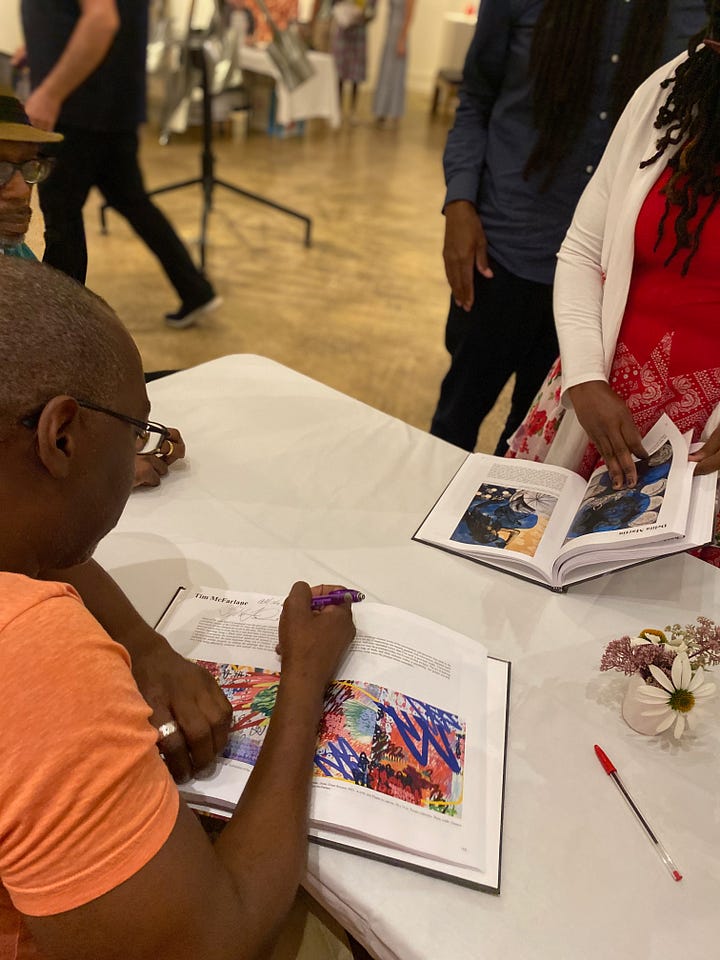 top: 2 photos of copies of the book, Shifting Time African-American Artists 2020-2021 on a table. Bottom: 2 photos of me signing copies of the book at the Woodmere Museum