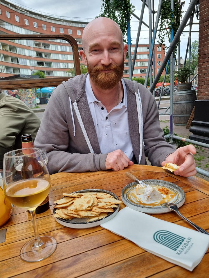 Photo 1: Aisling eating apple pie. Photo 2: Dave eating cheese and crackers. Photo 3: Dave grinning and eating from a red box with the words "cooked with lightning". Photo 4: Aisling grinning, holding a tray of chips covered in truffle mayo. 