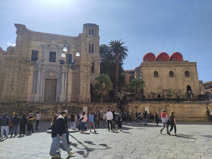 A large weather vane the size of a car and ornate buildings from Palermo