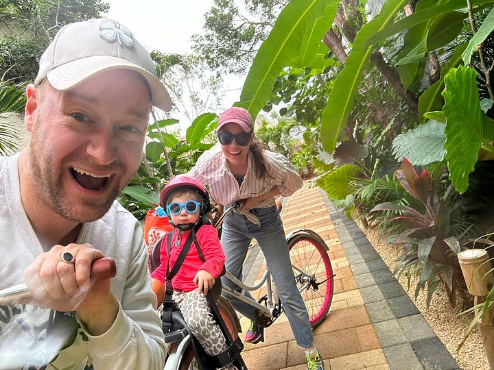 The Koch family smiling on bikes and on the beach. 