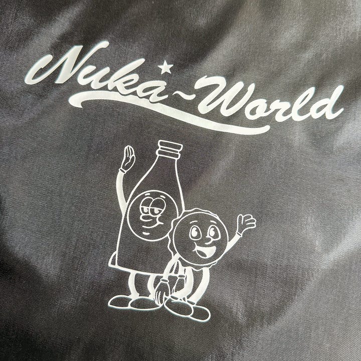 Red and black drawstring bags with Nuka World and picture of Bottle and Cappy