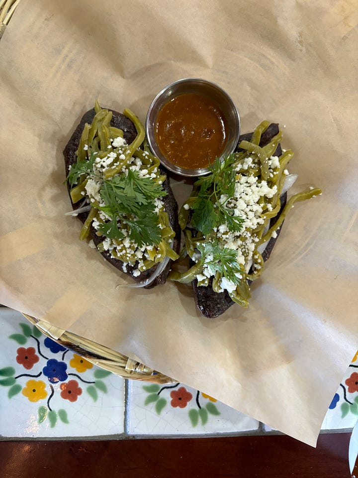 Nopales tlacoyos and tortillas with mole from Komal
