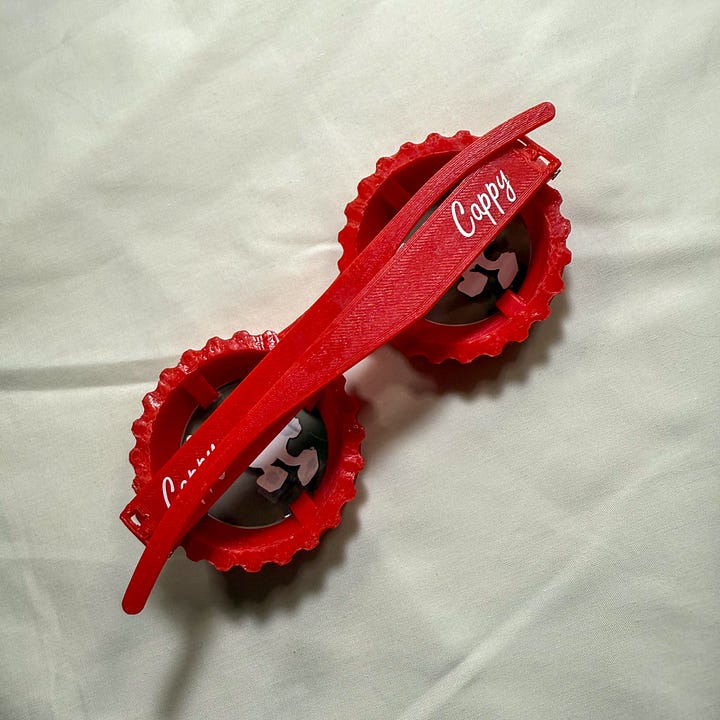 Red sunglasses shaped like bottle caps