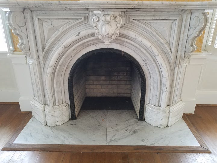 An elaborate window and a marble fireplace inside Laburnum.