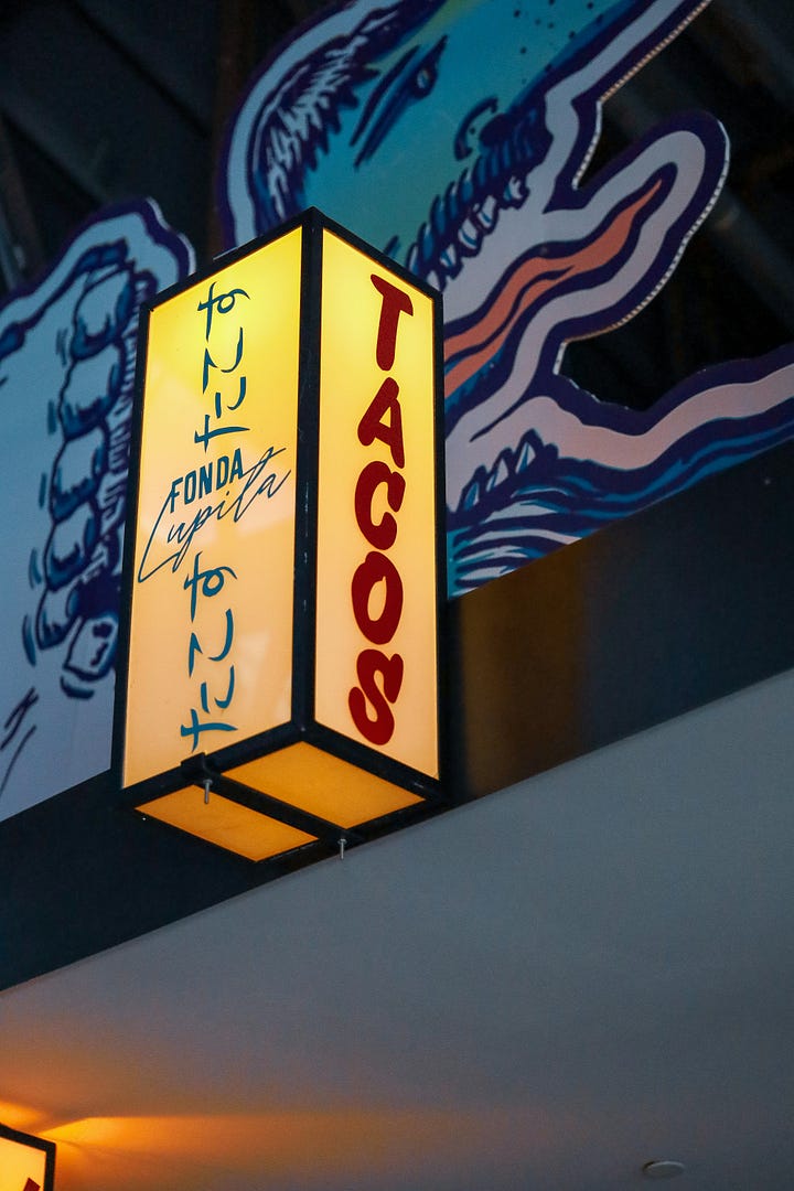 Taco sign with Japanese writing on it, Taco stand at night in Milwaukee, Photos by Brandon Griggs, TJ Dragotta Unsplash