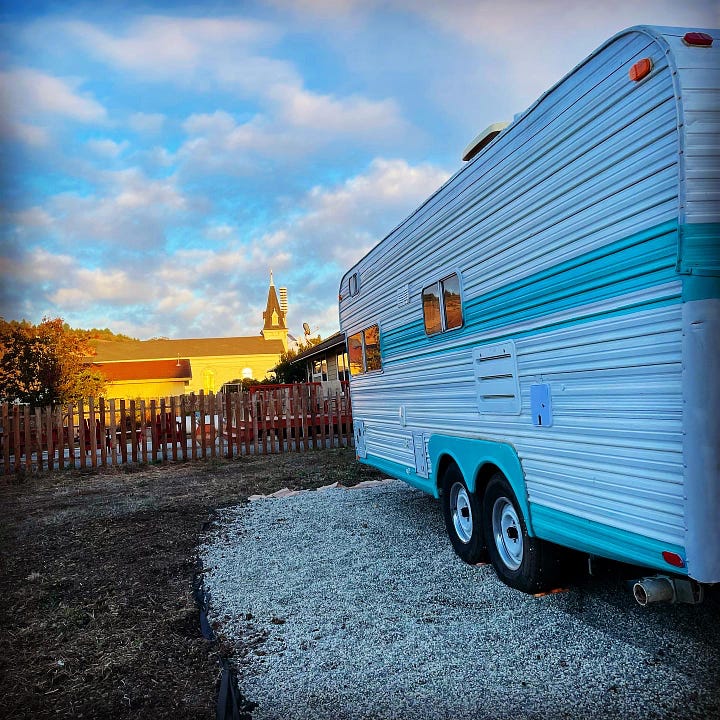 a chicken pen, a little rooster, two shots of a 70s-era travel trailer