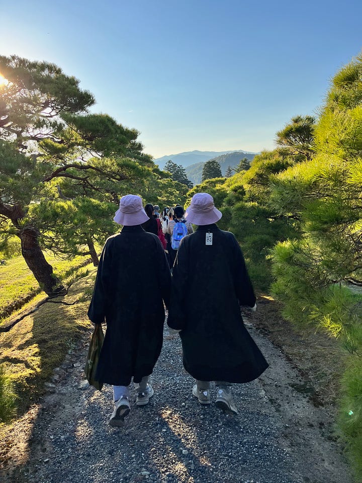 Two female monks and a hard-trying maple tree.