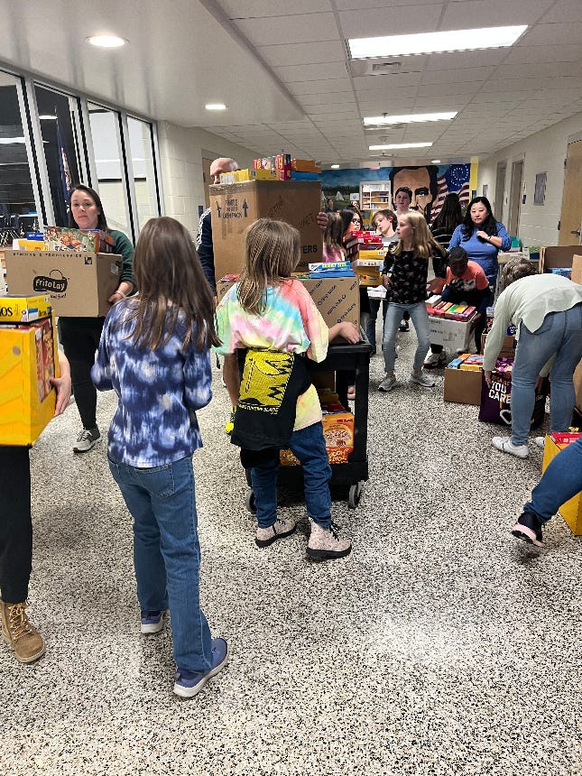Donated cereal boxes are set up in the Grafton Village Elementary School gym. Right: fifth grade students load the boxes onto pallets for pickup by the Fredericksburg Regional Food Bank.