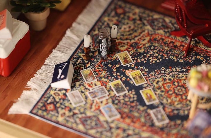 Close up images of the miniature room. Books Amber has written, the "Y: The Last Man" graphic novel, a photo of her husband, a typewriter, and tarot cards can be seen.