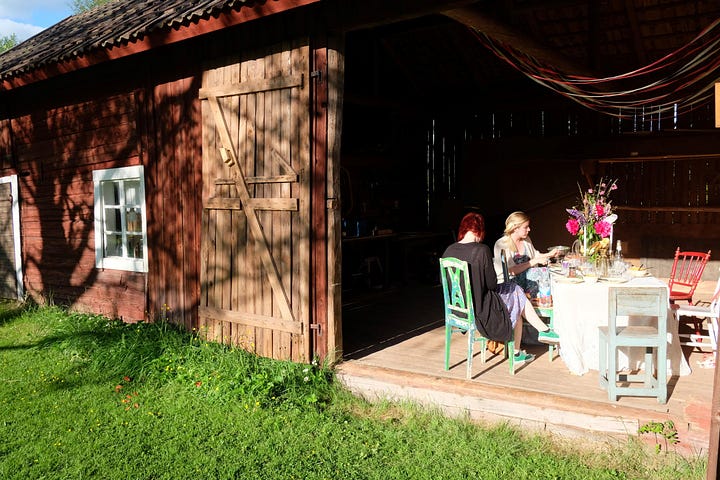 In the Swedish countryside at Midsommar, picking flowers, lunch in barns