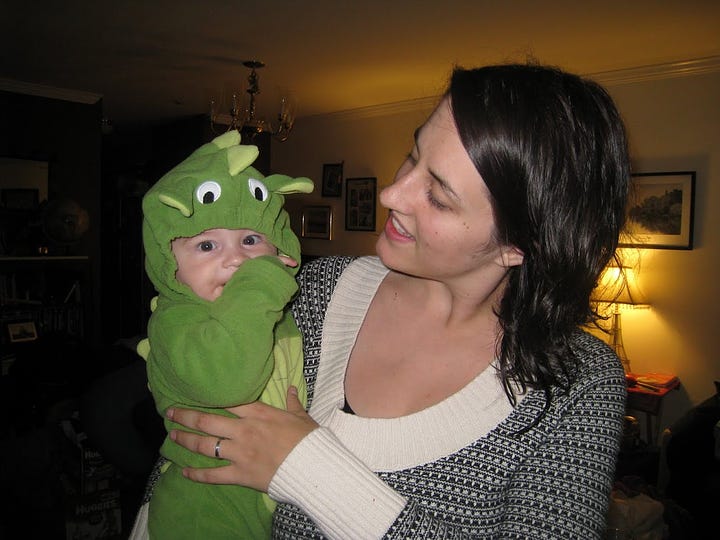 Elisa with baby in a dragon costume