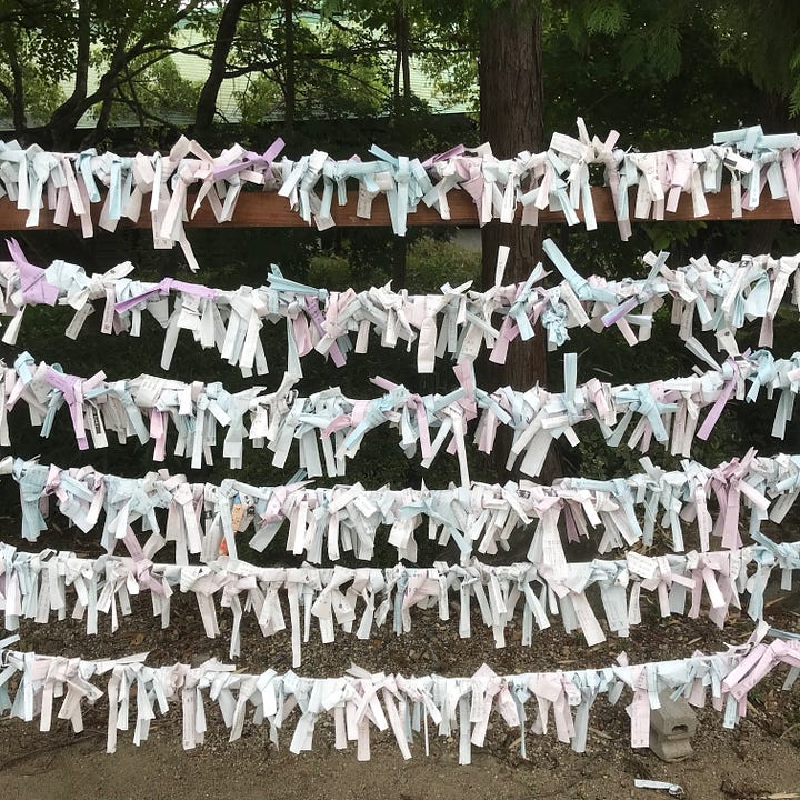 Pictures of Japanese prayers and fortune-telling strips left in shrines