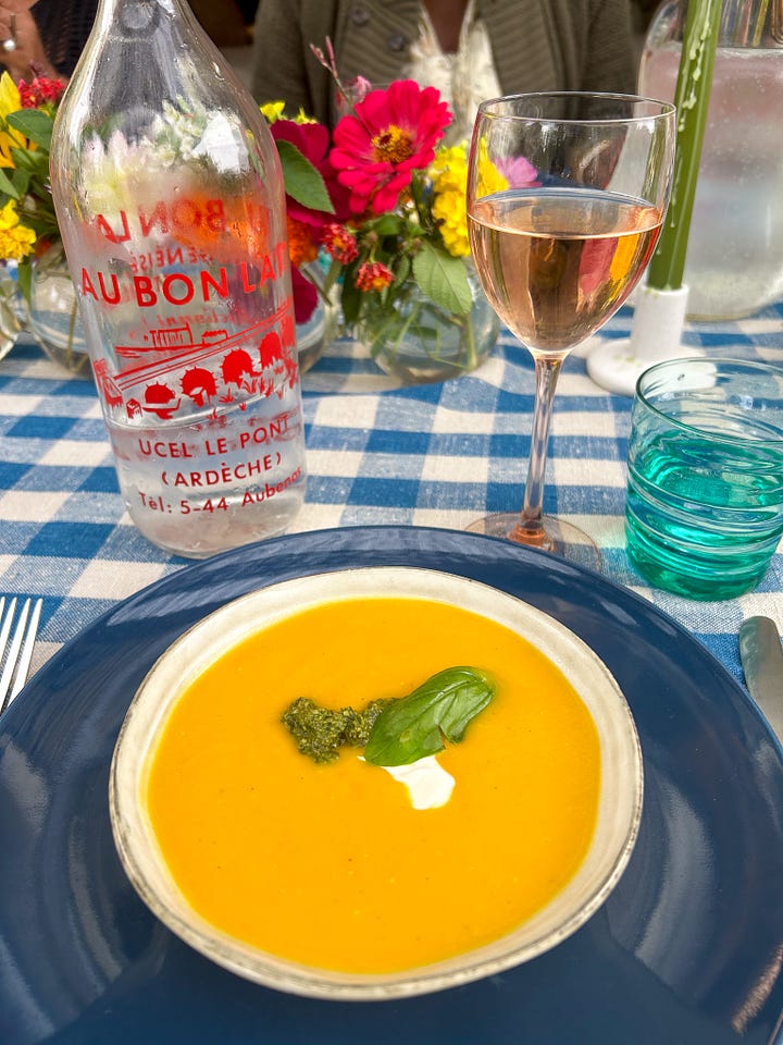 Colorful flowers, a tarte au soleil appetizer with pesto, and lunch on a pretty terrace