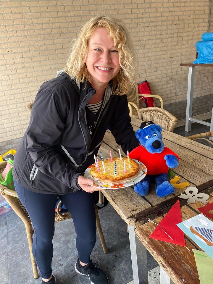 Karen Bussen with birthday cake and birthday decorations.