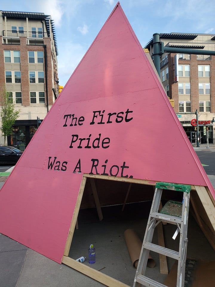 the three sides of the "queeramid" erected by the Chapel Hill government: "The First Pride Was A Riot", "Black Trans Lives Matter", and "Say Gay!"