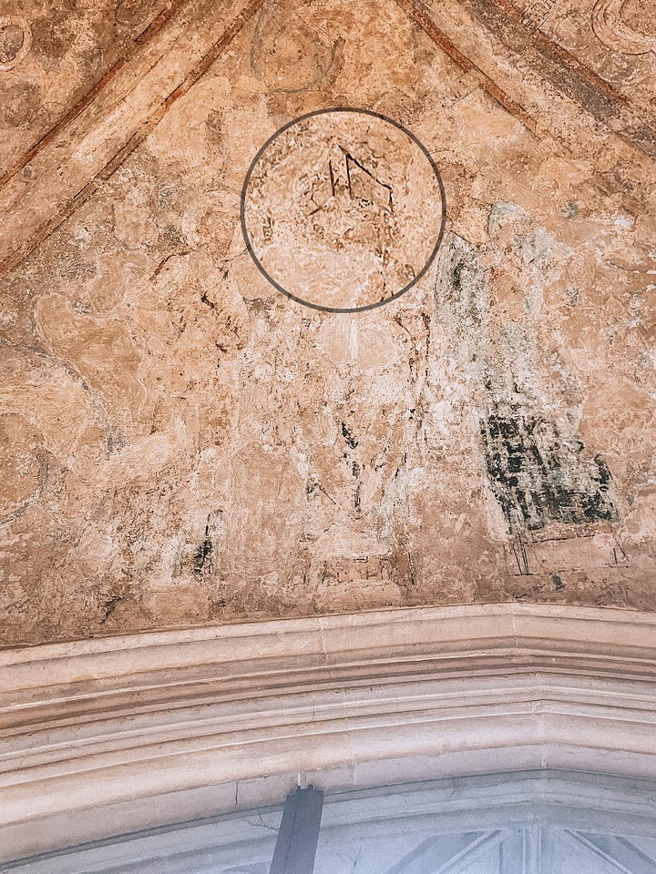 Zoomed in detail of St Edmund's crown and St Thomas Becket's mitre on a panel in Norwich Cathedral treasury.