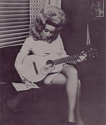 Dolly Parton writing a song with big hair, George Jones riding a lawnmower