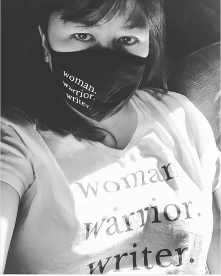 Anne Liu Kellor in a white Woman. Warrior. Writer. hoodie (left), Woman. Warrior. Writer. White T-Shirt (right)